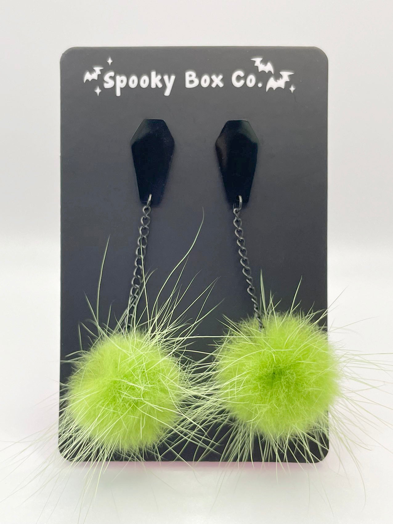 Green pom store pom earrings